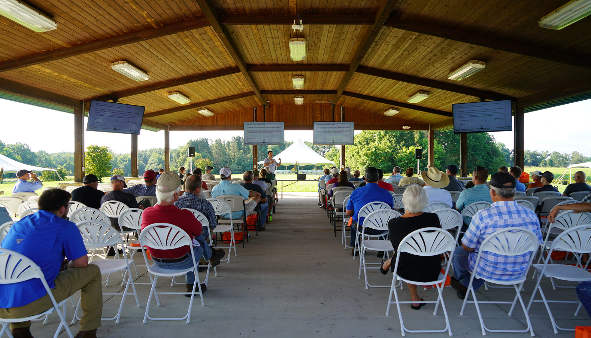 Attendees attend a presentation at the Program Shelter on the Plateau AgResearch and Education Center.